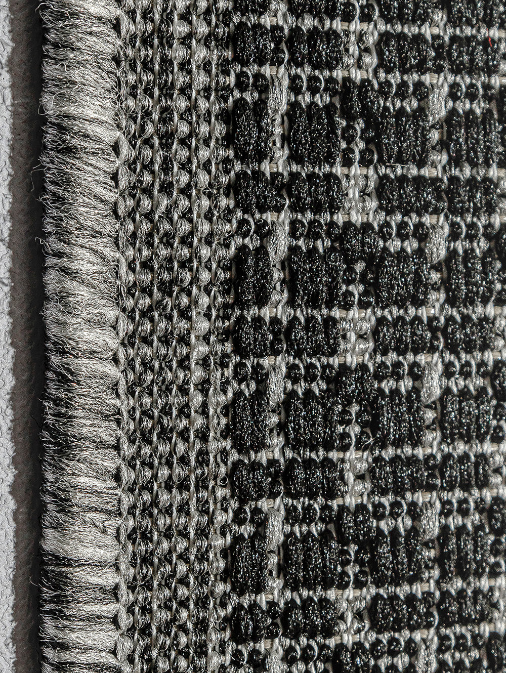 Detalle macro del tejido de alfombra de sisal grafito.